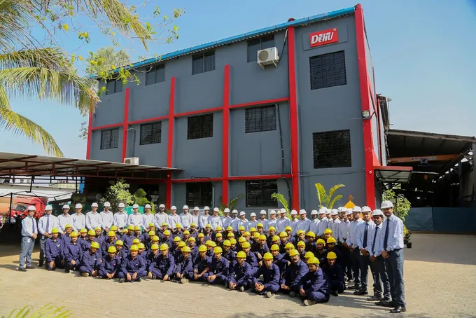 Group engineering and manufacturing team in front of their facility